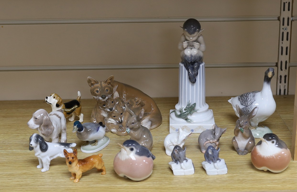 Sixteen various Royal Copenhagen porcelain birds and animals, including a faun playing pipes, a fox group and a metal foxhound, faun 21 cms high